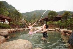 Tourists are enjoying the hot spring in Yellow Mou