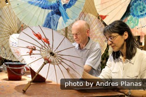 China Highlights customers making painted paper umbrellas in Hangzhou
