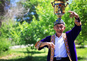 Uyghur man dancing with a vessel on his head