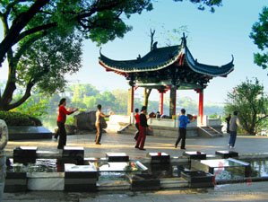 People are Practicing Taichi along the bank of lake