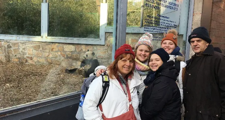 Our clients are taking photos with panda in Beijing Zoo.