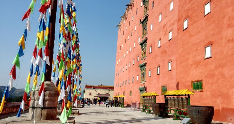 red building and prayer flags