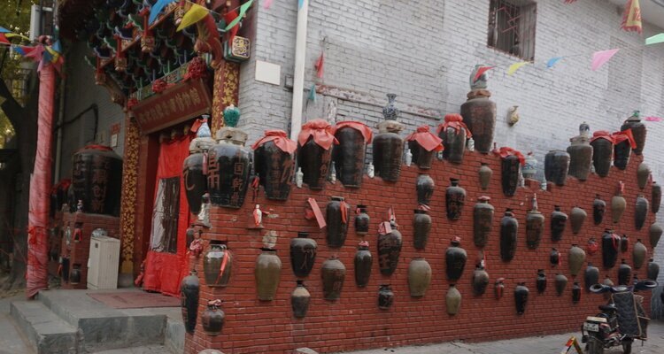 wall with wine jars in a hutong