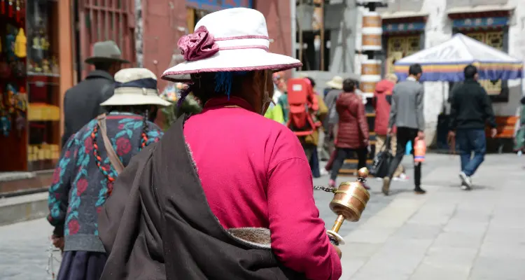 people holding the prayer wheel