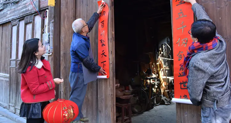 Putting Up Spring Couplets to celebrate chinese new year