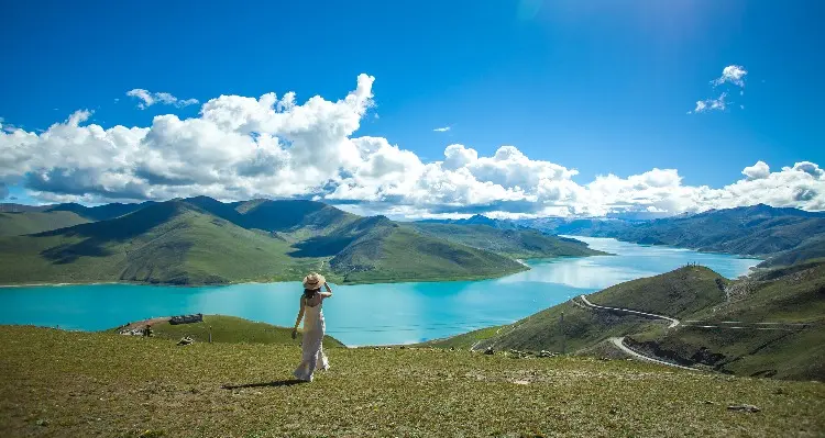 a lady on the bank of Lake Yamdrok