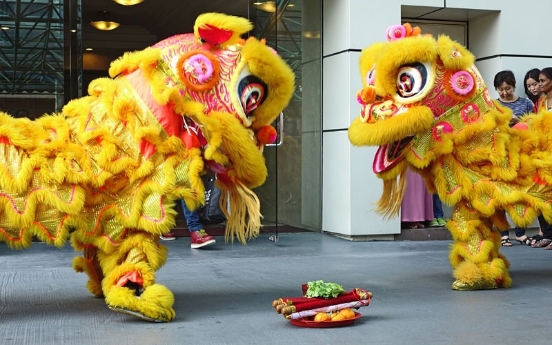 Entertainers perform lion dance during the opening ceremony of the