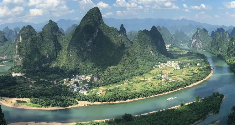 Enjoy the peaks and the river from the top of a hill