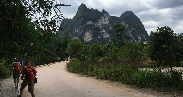 Our(China Highlights) two male guests are hiking towards the Nine Horses Painting Mountain in Yangshuo, Guilin.