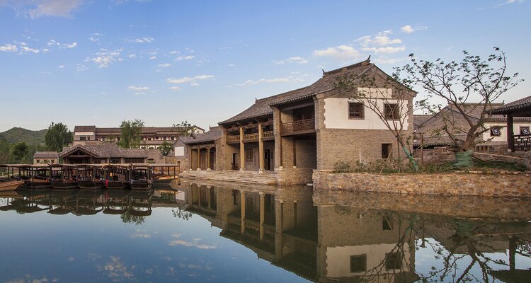 In Gubei Water Town, Beijing, old houses stand on the tranquil, mirror-like water.