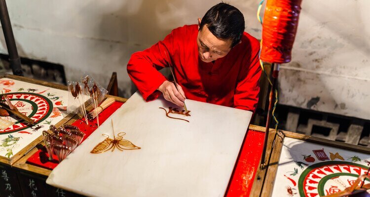 The craftsman is making sugar painting in Jinli