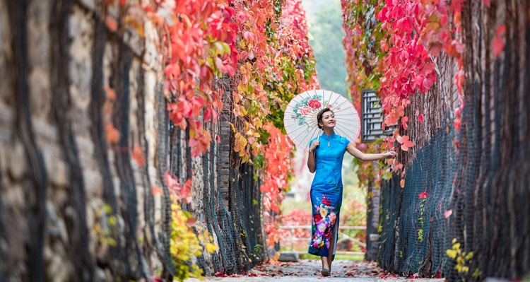 A lady with a blue dress and a umbrella 