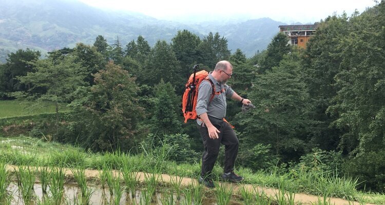 Our client is try to hike along the terrace field's rim