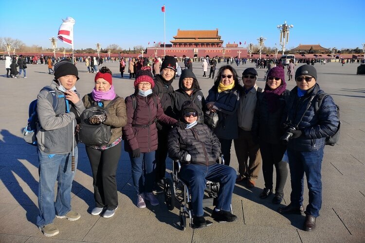 Our family guests use a wheelchair to visit Tiananmen Square