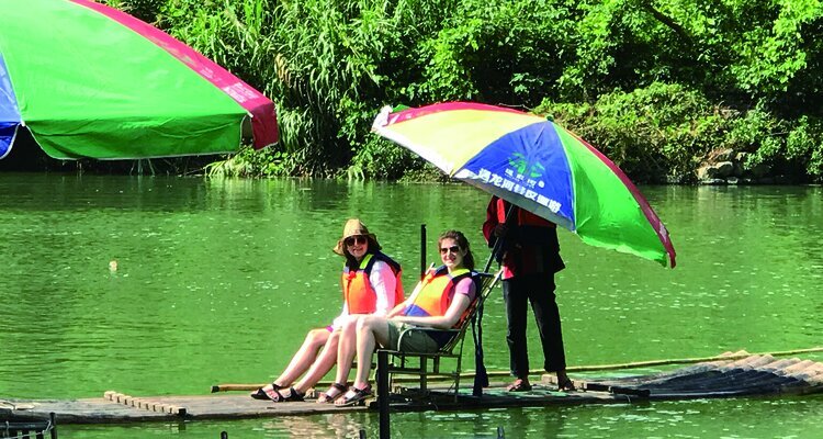 Our clients are enjoying serene bamboo rafting in the Jima part in Yangshuo China