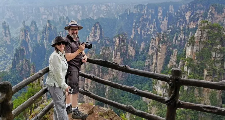 a couple are enjoying the view of the mountains