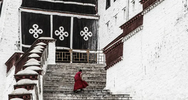 A monk with red dress on Potala Palace