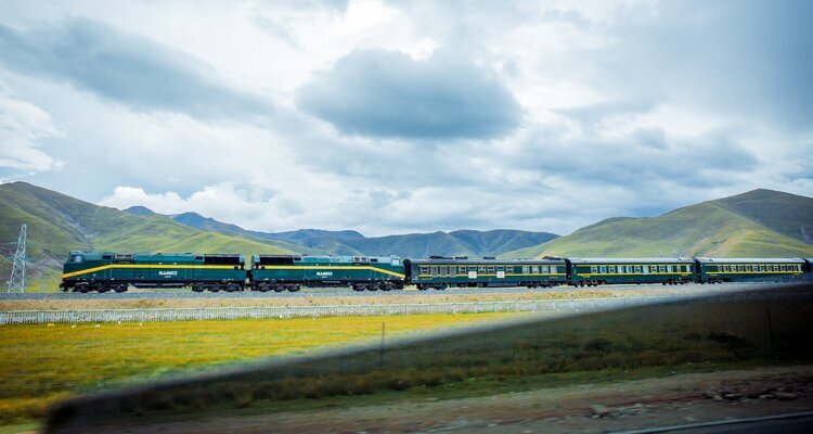You will travel along the Qinghai–Tibet Railway by train.