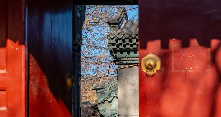 the red door of a courtyard in hutong