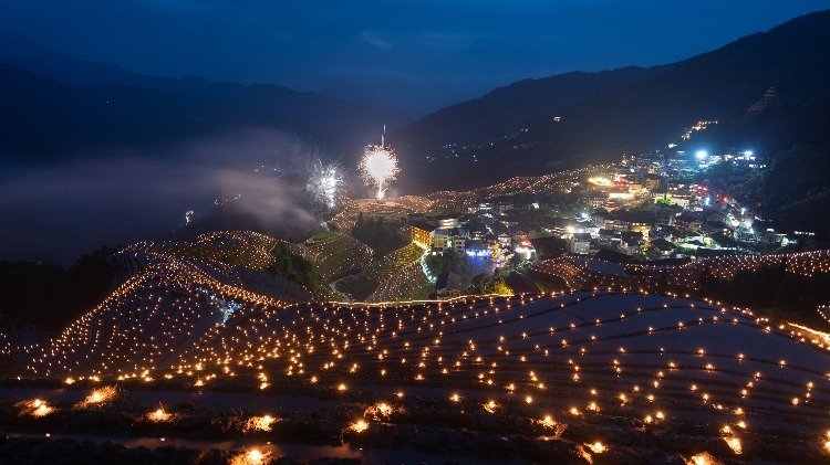 The rice terraces are lit up after night falls, like stars shining in the fields