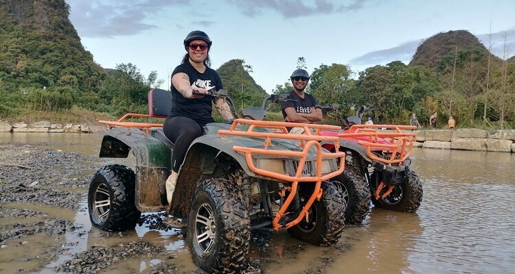 A white couple driving a four-wheel drive vehicle in rural Yangshuo