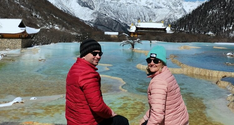 a couple sitting by the lake