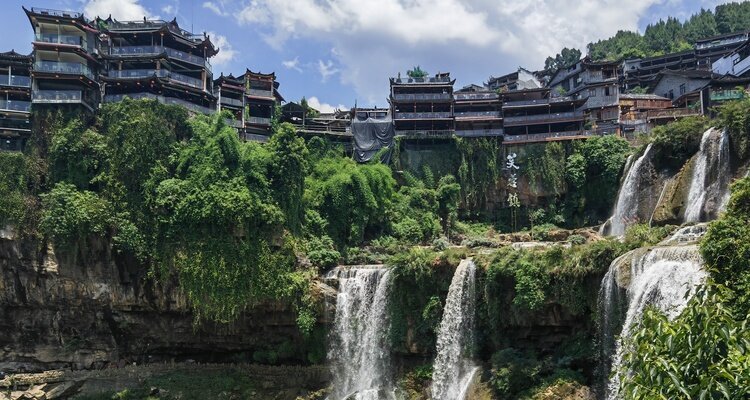 Furong Ancient Town in Hunan Province is an ancient village perched on a cliff beside a waterfall.