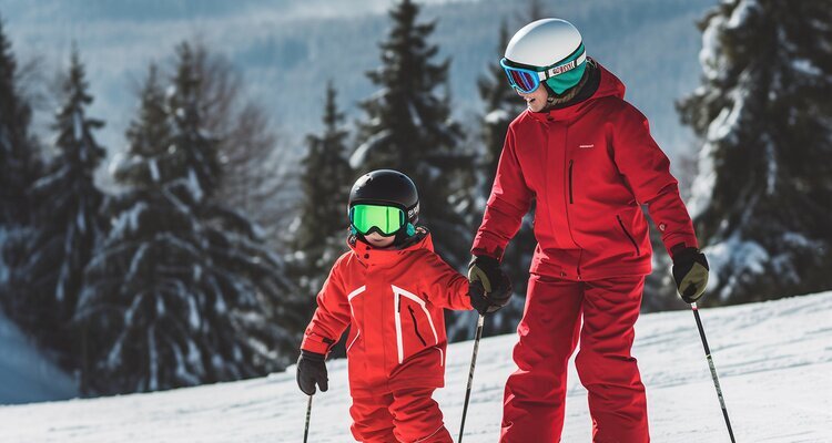 Mother skiing with her child family