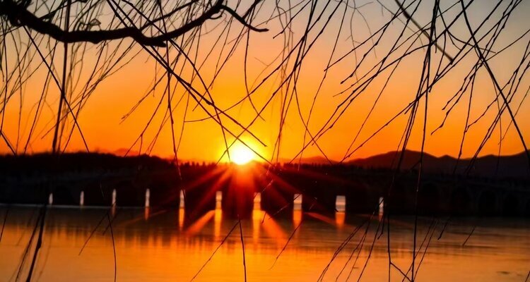 The golden light is shining through the hole in the Summer Palace in Beijing.