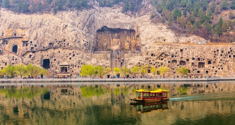 Willow trees and Longmen Grottoes reflecting on the river