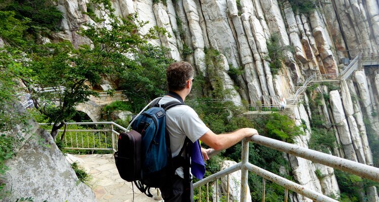 Tourist hiking on the trail and admiring Shuce Cliff