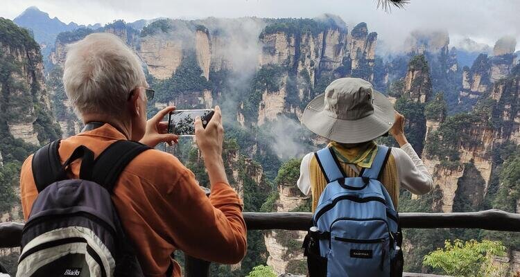 Our elderly white guests were photographing the Hallelujah Mountains of Zhangjiajie shrouded in autumn mist.