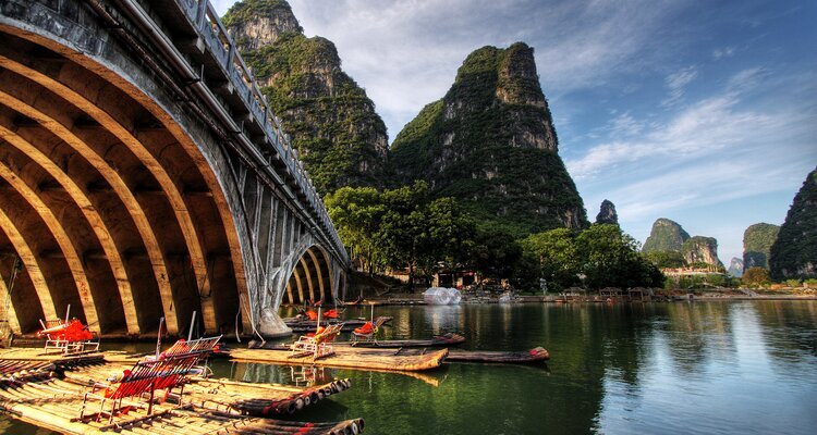 Our clients are watching sunset after experiencing the bamboo rafting to the Gongnong Bridge in Yangshuo China